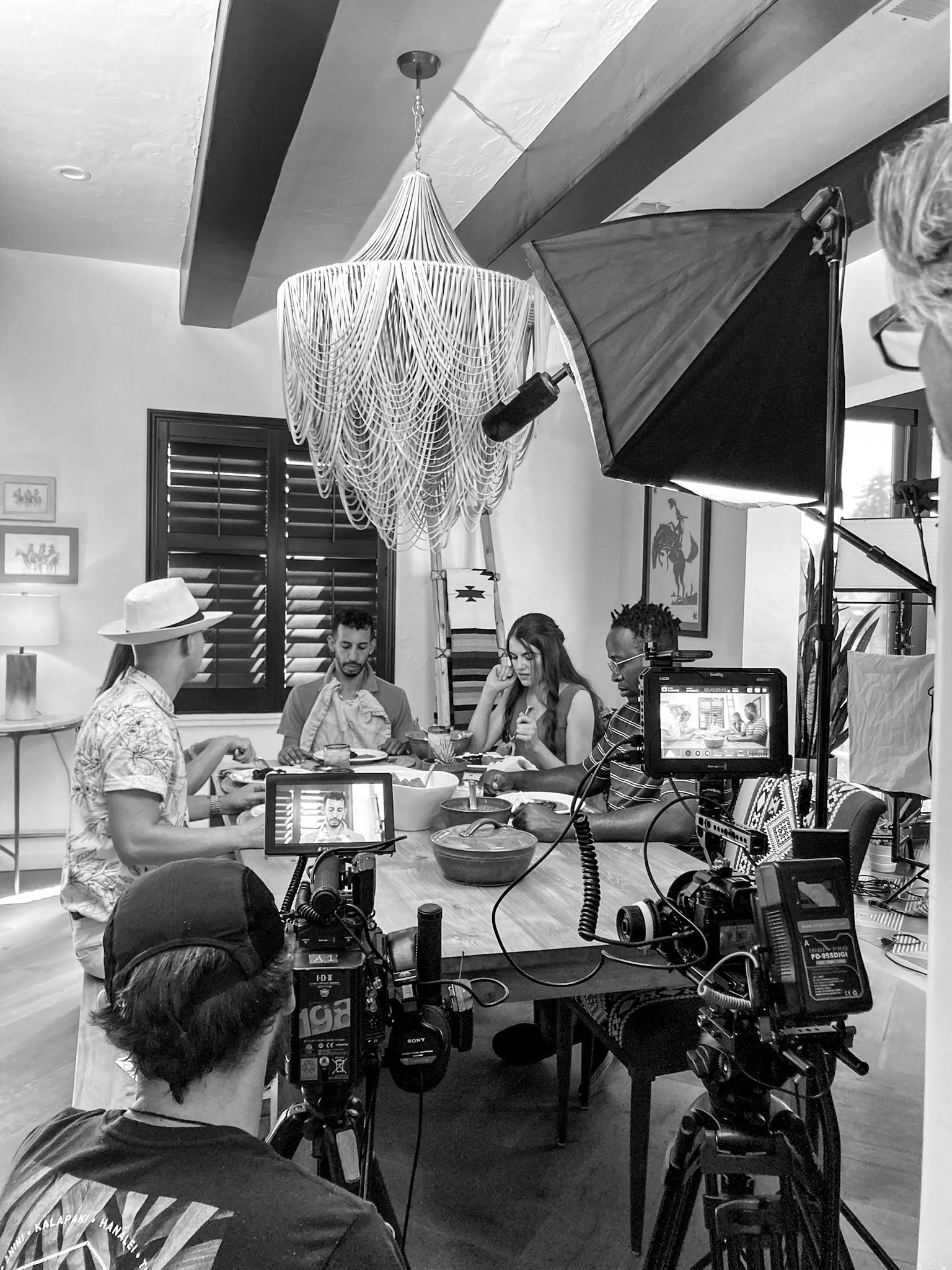 Film crew shooting a dinner scene on set