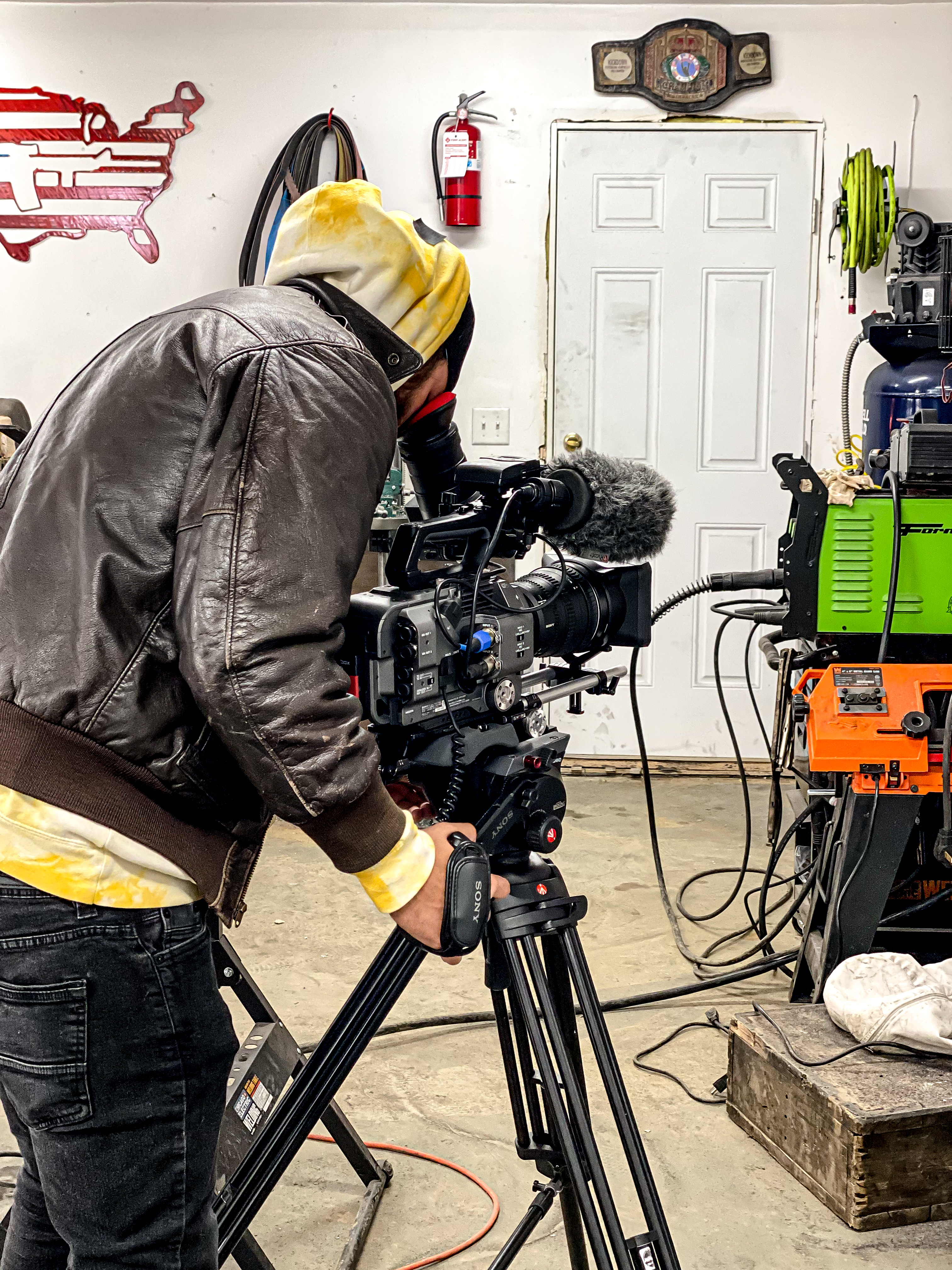 Filmmaker operating camera on location